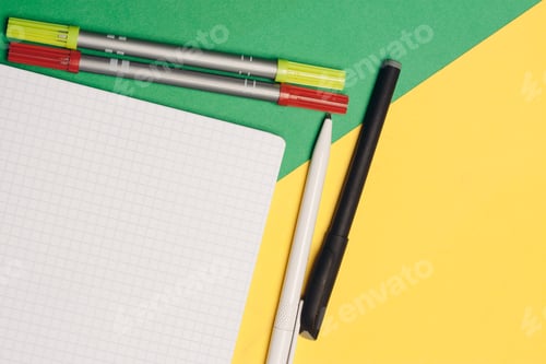 Preview: office supplies pens and notepads on yellow green background