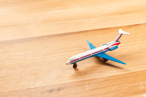 Preview: Toy of passenger plane on wooden background