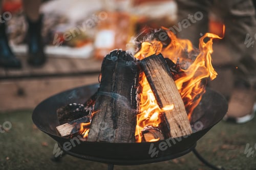 Preview: couple in love millennial traveler kindles firewood for grilling in autumn near trailer mobile home
