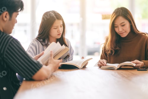 Preview: Group of people sitting and enjoyed reading book together on wooden table