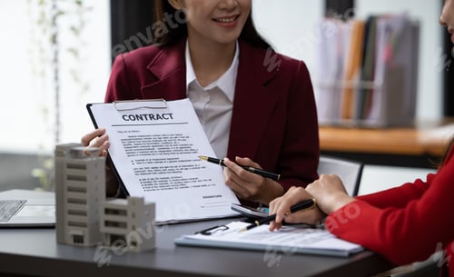 Preview: Asian businesswoman making a deal to buy a house or condo inside the office, home insurance concept