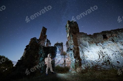 Preview: Young man in white suit research ancient ruins.
