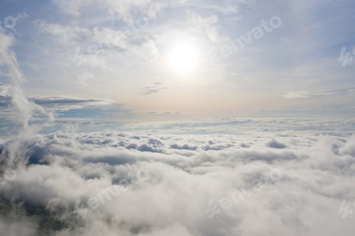 Preview: Aerial view of sunrise above fluffy sea fog misty clouds with mountain hill. Nature landscape