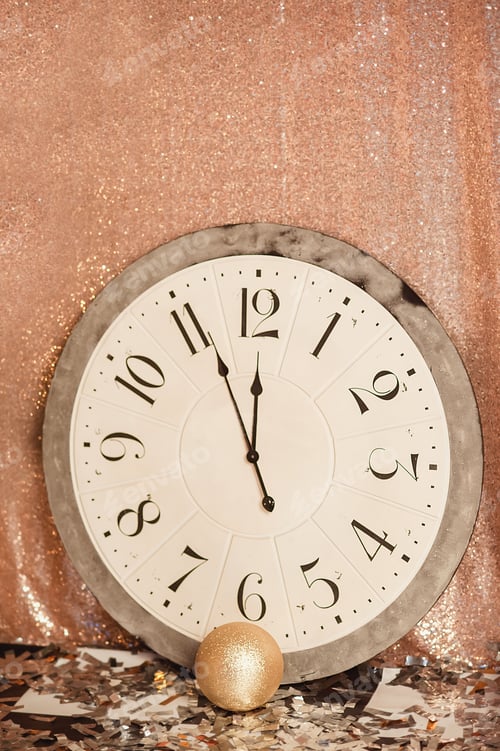 Preview: Vintage alarm clock in room showing five to midnight. Happy New Year starry background