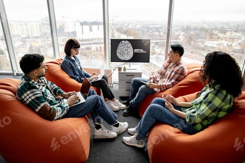 Preview: Professionals with gadgets working on AI project in office