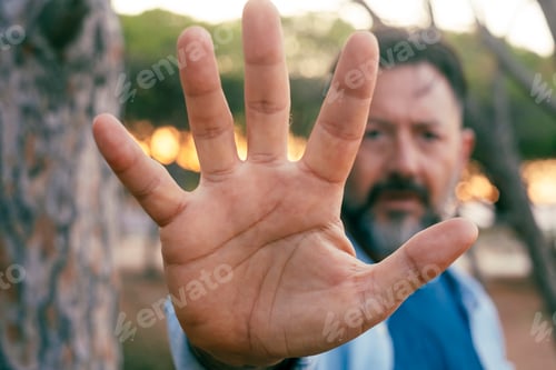 Preview: One man put his hand in front of the camera to stop. Serious expression. Against climate change hope