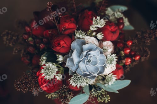 Preview: beautiful wedding bouquet with red roses and succulents
