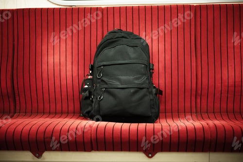 Preview: a black bag on the seat in bus. Abandoned, unattended cabin backpack on chair inside subway train.