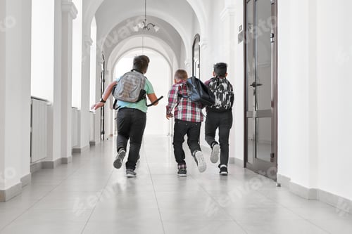Preview: Group of schoolboys with school backpacks running