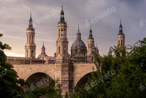 Preview: Cathedral Basilica of Our Lady of Pillar with bridge and trees at Zaragoza.
