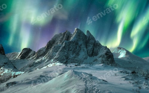 Preview: Aurora borealis over majestic mountain in snowy on Segla Island