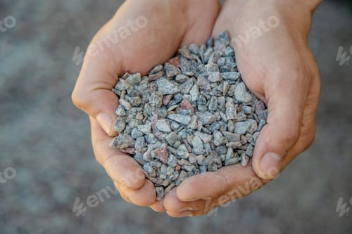 Preview: Man holding small rubble in his hands selective focus