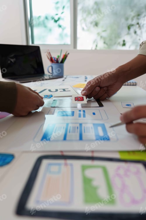 Preview: Collaborative UX UI Design Process. Team discussing wireframes and user interface layouts.