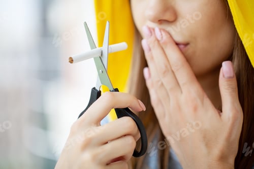 Preview: Stop smoking, woman cuts a cigarette with scissors