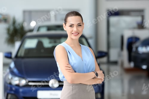 Preview: Attractive young saleswoman in car dealership
