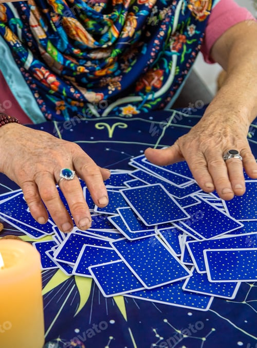 Preview: Fortune teller reads tarot cards. selective focus.