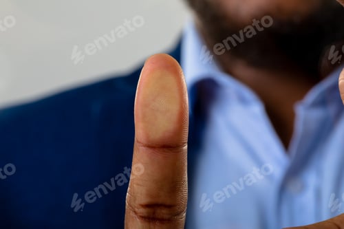 Preview: Close up of businessman touching invisible screen against grey background