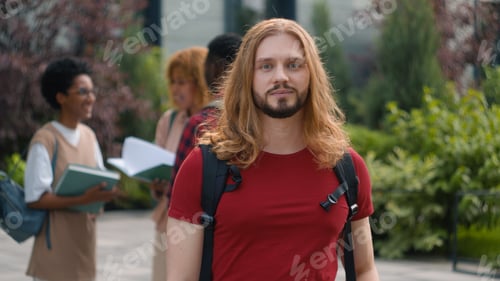 Preview: Happy Caucasian student guy man male schoolboy in city outdoors university college campus showing