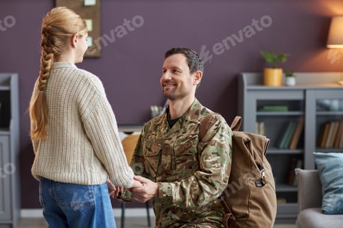 Preview: Loving father wearing military uniform holding hands with teen daughter