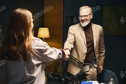 Man Shaking Hand With Journalist