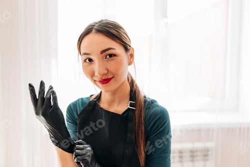 Preview: Cosmetologist doing permanent makeup tattooing for brows in her office. Beautiful Asian woman work
