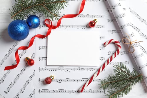 Preview: Flat lay composition with Christmas decorations and blank paper on music sheets
