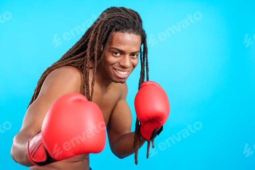 Preview: Professional latin male boxer with dreadlocks wearing red boxing gloves