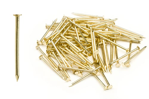 Pile of Golden Nails on White Background