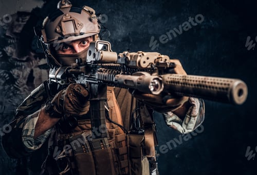 Preview: Special forces soldier in camouflage uniform holding an assault rifle with a laser sight