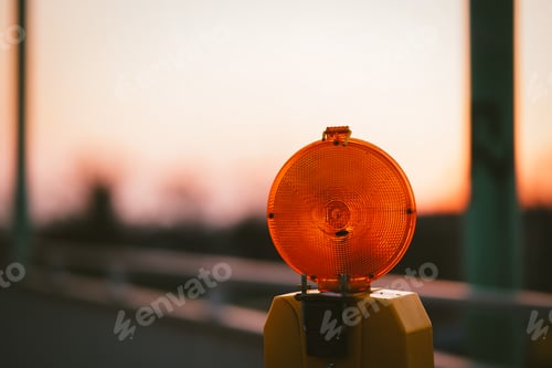 Preview: Closeup shot of the warning light on a bridge at the sunset