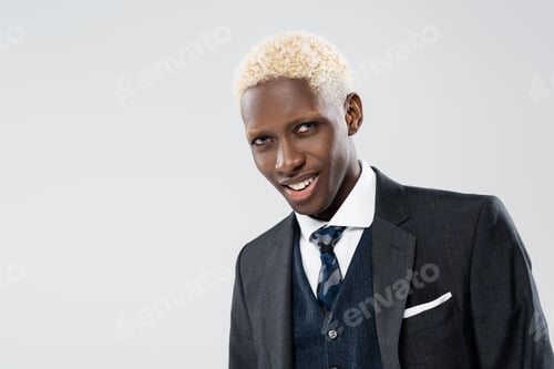 Preview: smiling and young african american man in suit isolated on grey