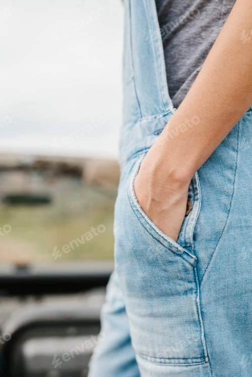 Preview: A woman standing up in a jeep looking around at the landscape.