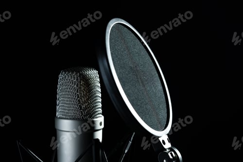 Preview: Professional microphone against black background in studio