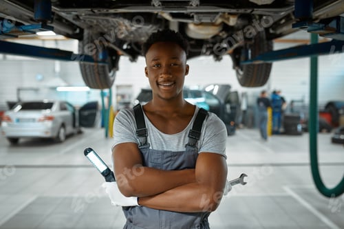 Preview: Male worker checks car suspension, auto service