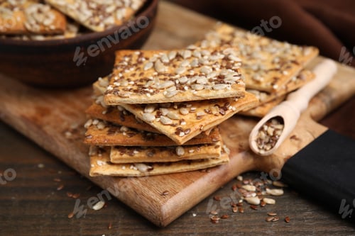 Preview: Cereal crackers with flax, sunflower and sesame seeds on wooden table, closeup
