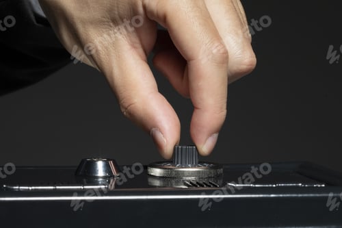 Preview: Closeup shot of a hand opening the lock of a safe