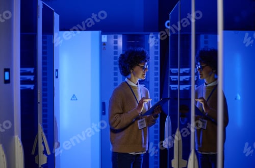 Preview: Female IT engineer working in server room