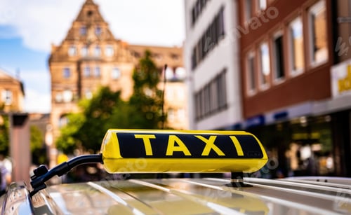 Preview: Yellow taxi sign in old historical town