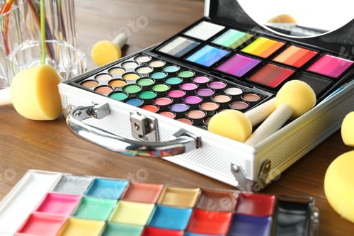 Preview: Face paints and tools on wooden background, closeup