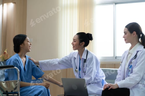 Preview: Two female doctors at an international hospital giving advice to convalescent patients