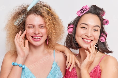 Preview: Portrait of cheerful good looking women with healthy skin do hairstyle for special occasion wear dre