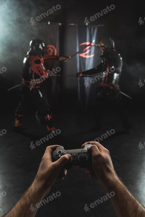 Preview: cropped shot of playing samurai fighting with gamepad in real life