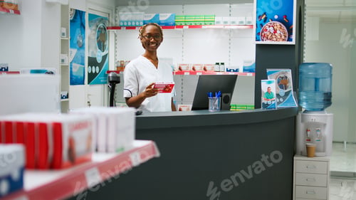 Preview: African american specialist working at pharmacy with pharmaceutical products
