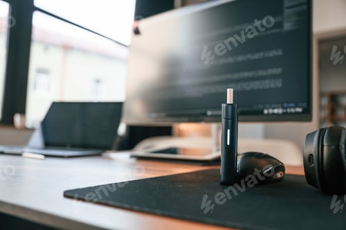 Preview: Close up view of electronic cigarette, mouse for computer, laptop and monitor