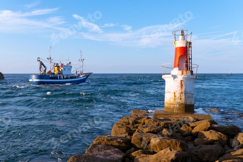 Preview: Lighthouse on rocky coastline