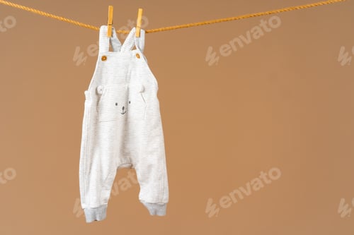 Preview: Kid's apparel pinned to a clothesline to dry