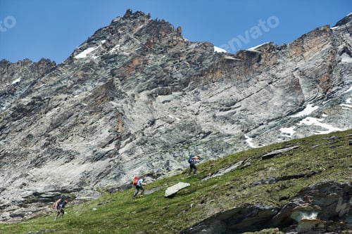 Preview: Tourists following path in mountains.