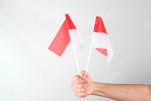 Preview: Hand holding red and white Indonesia flag attribute.