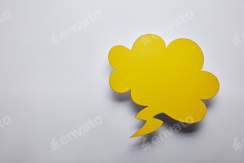 Preview: top view of empty yellow thought bubble on grey background