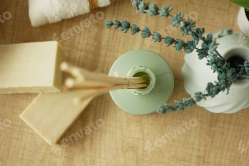 Preview: A decorative vase featuring wooden sticks and fresh greenery